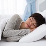 content-young-asian-woman-sleeping-bed_1262-4943