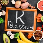 food-contains-natural-potassium-k-potatoes-mushrooms-banana-tomatoes-nuts-beans-broccoli-avocados-top-view-black-background_187166-2389