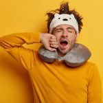 male-passenger-wears-travel-pillow-sleeping-journey_273609-36747