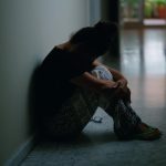 middle-age-hispanic-woman-suffering-domestic-violence-with-bruise-eyes-sitting-floor-home_839833-32724