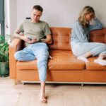 aaa1ccfc986985861fa511dae940b864-couple-sits-on-a-couch-facing-away-from-each-other-on-their-phones_l